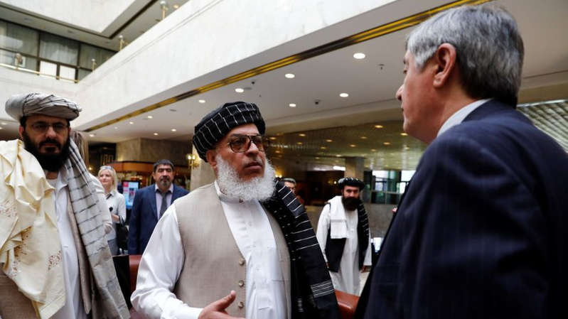 Saeed Mortazavi et al. standing in front of a building: Russia's special Afghanistan envoy (R) has been talking to Taliban leaders for some years